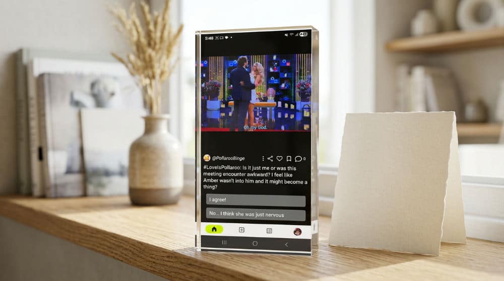 A modern acrylic photo block and a traditional paper card displayed together on a white shelf.